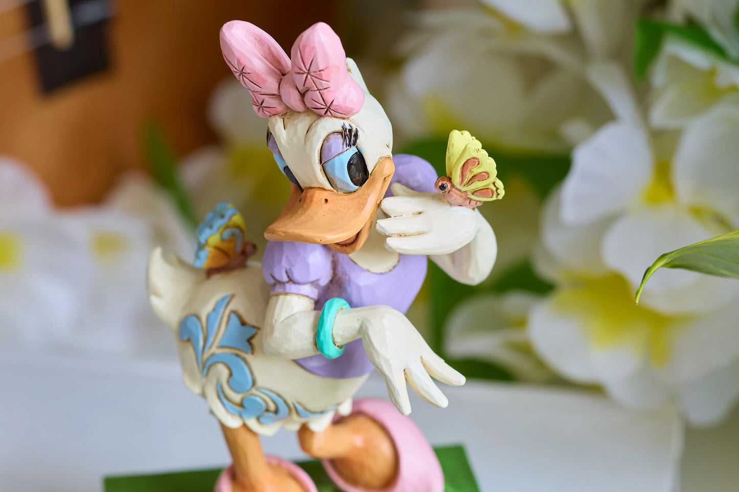 Enesco Disney Traditions Collection by Jim Shore Daisy Duck with Flowers and Butterflies Figurine- Stone Resin Hand Painted Collectible Disney Figurines Home Decor Statue, 5 Inch