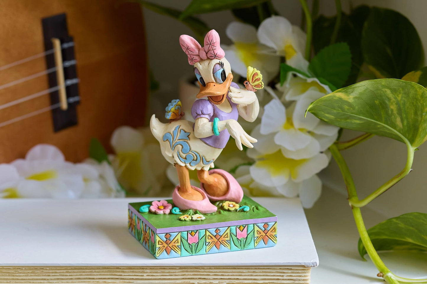 Enesco Disney Traditions Collection by Jim Shore Daisy Duck with Flowers and Butterflies Figurine- Stone Resin Hand Painted Collectible Disney Figurines Home Decor Statue, 5 Inch