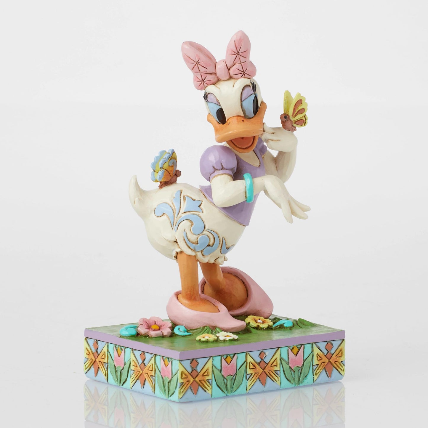 Enesco Disney Traditions Collection by Jim Shore Daisy Duck with Flowers and Butterflies Figurine- Stone Resin Hand Painted Collectible Disney Figurines Home Decor Statue, 5 Inch
